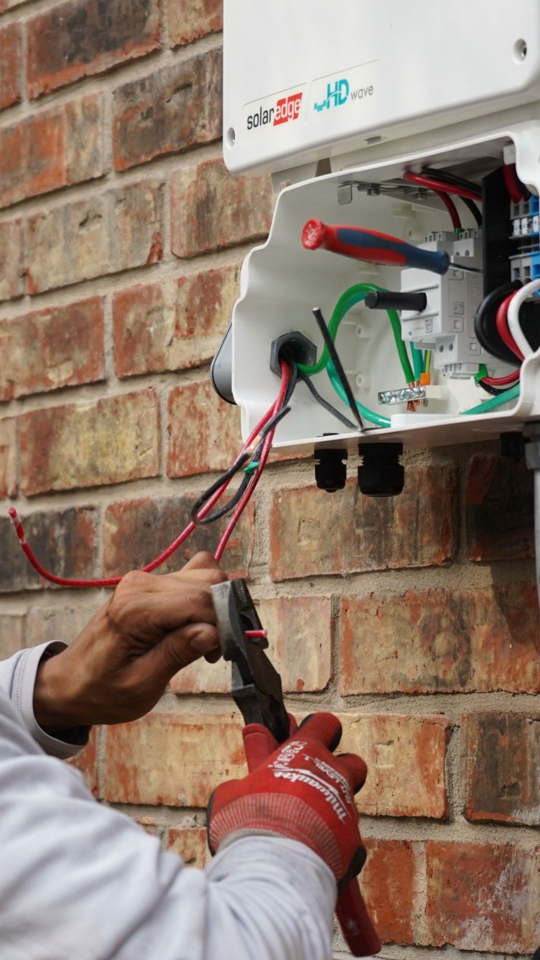 Worker installing a solar system to a house