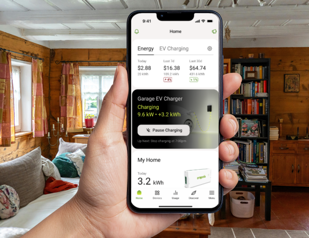 someone holding a phone in their had using the Emporia Energy app in their living room