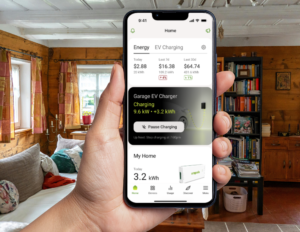 someone holding a phone in their had using the Emporia Energy app in their living room