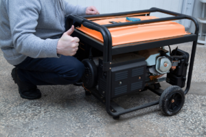 A man standing next to an orange generator